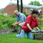 travaux dans le jardin entre un grand père et son petit fils